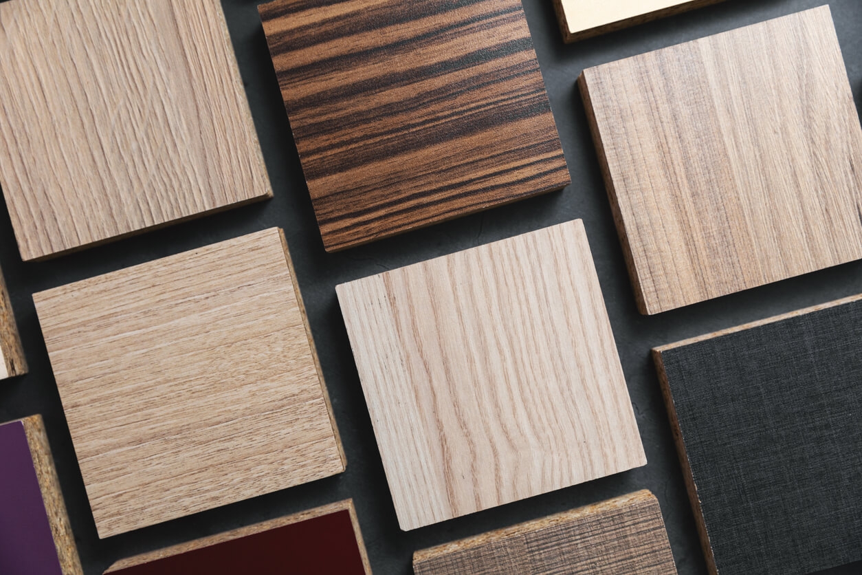 Several wood samples lined up on a black background.