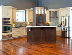 KDI Kitchen-designed contemporary kitchen with white cabinets, dark island, and stainless steel appliances