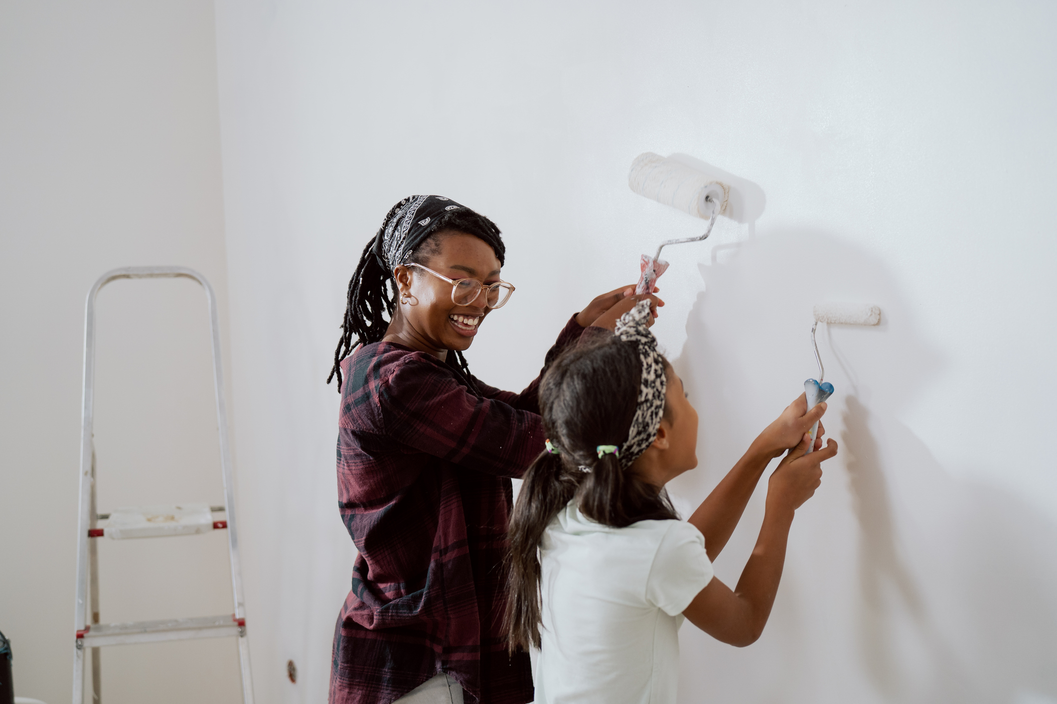 A mother and daughter using a weekend to refresh the pain in their kitchen.