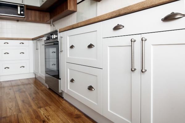 A clean set of kitchen cabinets with handles like these can make your kitchen more functional.