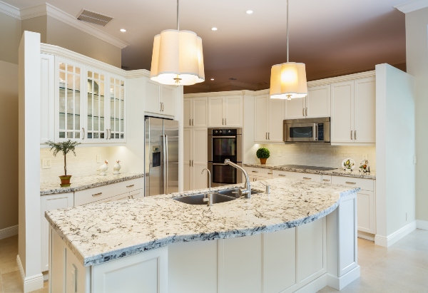 A kitchen with a sturdy island has durable, long-lasting granite countertops to keep up with anything your family will need.