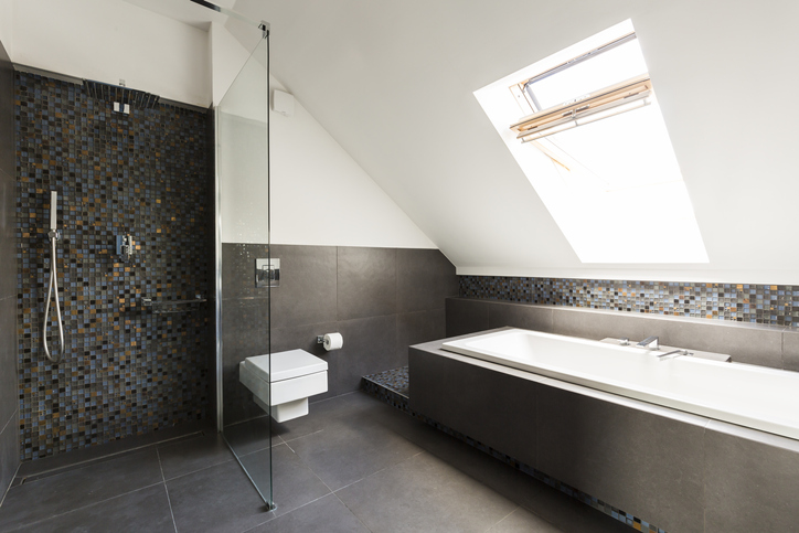 A shot of a bathroom with a separate, luxurious bathtub and a standup shower. 